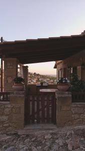 a patio with a wooden table and a building at Το Αρχοντικό του Κάστρου in Kyparissia