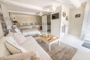 a white living room with a couch and a table at Cocon de Morgon in Villié-Morgon