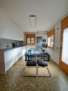 a large kitchen with a table and chairs in it at "Cal Tu" in San Fausto de Campcentellas