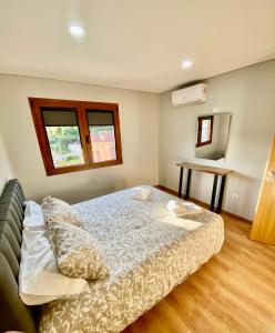 a small bedroom with a bed and a mirror at Chalé da Boucinha in Celorico de Basto