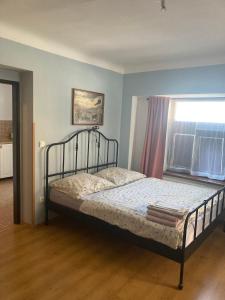 a bedroom with a bed in a room with a window at Apartman Centrum in Jičín +11 photos