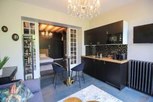 a kitchen with a counter and a room with a bed at G7 Loft SPA & Terrasse centre Angouleme in Angoulême
