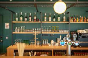 a bar with lots of bottles of alcohol on shelves at Hôtel AKENA Strasbourg - Hoerdt in Hoerdt +44 photos