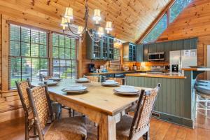 a large kitchen with a wooden table and chairs at Serendipity in Townsend