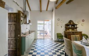 a kitchen with a checkered floor at Gorgeous Home In Villanueva Del Rio Y M in Villanueva del Río y Minas
