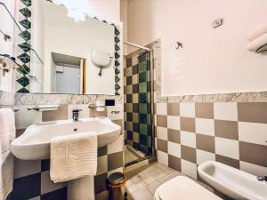 a bathroom with a sink and a toilet at GALA Apartments - Charme Barocco a due passi da Piazza Duomo in Lecce +27 photos