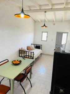 a living room with a table and a bed at Casita Larraun- tu espacio cálido en la tranquilidad de Navarro in Navarro +6 photos