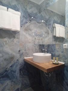a bathroom with a sink on a wooden counter at ΘωΜΑΙΣ in Glykadi +31 photos