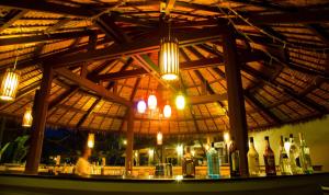 a bar in a restaurant with bottles of wine at Maehaad Bay Resort - SHA Plus in Mae Haad