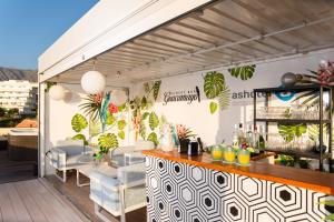 a restaurant with a bar on a patio at HOVIMA Jardin Caleta in Adeje