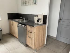a kitchen with a sink and a counter top at Le Clos Joli 62 in Landrethun-le-Nord