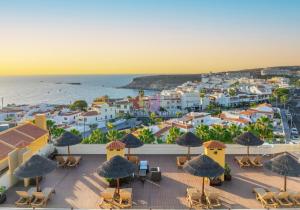 an aerial view of a town with chairs and umbrellas at HOVIMA Jardin Caleta in Adeje +28 photos