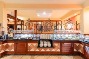 a kitchen with a counter with dishes on it at HOVIMA Jardin Caleta in Adeje