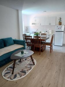 a living room with a couch and a table at Apartmani Bubamara Leskovac in Leskovac