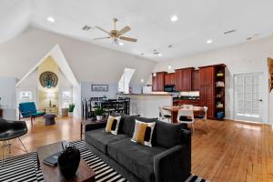 a living room with a couch and a kitchen at The Uplifting Mansion in Milwaukee