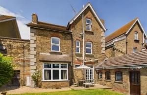 an exterior view of a brick house at Ocean view double with ensuite, with access to private garden and bike store in Margate