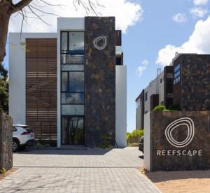 a building with a sign in front of it at ReefScape Beachfront Residence in Trou aux Biches