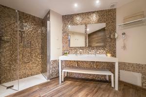 a bathroom with a sink and a shower at Boutique Hotel Torre Di Cala Piccola in Porto Santo Stefano