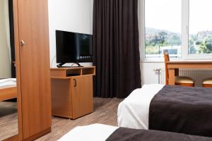 TV a/nebo společenská místnost v ubytování Hotel Luxor