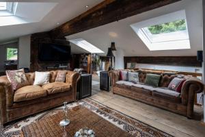 a living room with two couches and a television at Jagerbauerngut in Wimm +29 photos