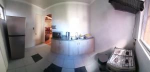 a small kitchen with a sink and a refrigerator at Casa Jardín del Mar - Reñaca - 4 Dormitorios - Aire Acondicionado in Viña del Mar