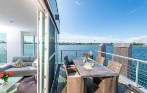 a balcony with a table and chairs on a boat at Waterfront in Olpenitz