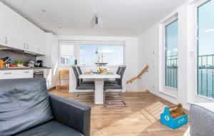 a kitchen and living room with a table and chairs at Waterfront in Olpenitz