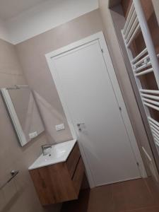 a bathroom with a sink and a mirror at Apartment Emanuela in Porto Cesareo +32 photos
