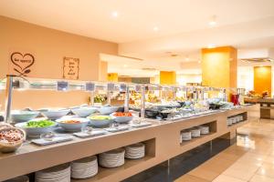 a buffet line with bowls and plates of food at HOVIMA Santa Mar&iacute;a in Adeje