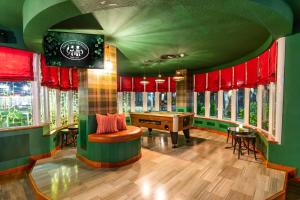 a living room with a pool table and windows at HOVIMA Santa María in Adeje
