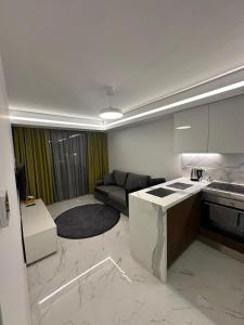 a kitchen and a living room with a couch at Grand Sapphire Resort Casino in Iskele