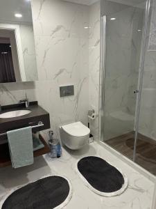 a bathroom with a shower and a toilet and a sink at Grand Sapphire Resort Casino in Iskele
