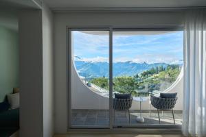 a room with a large window with a view of mountains at Hemma 俬宅 in Renai