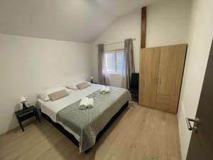 Postel nebo postele na pokoji v ubytování Apartman Leina