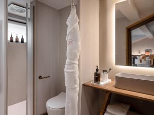 a bathroom with a white towel hanging next to a sink at Coeur de Megève in Megève +37 photos