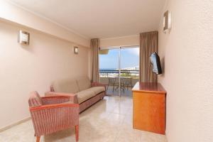 a living room with a couch and a tv at HOVIMA Santa María in Adeje +49 photos