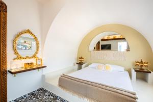 a bedroom with a bed and a mirror at Gorgona Traditional 3 in Karpathos Town
