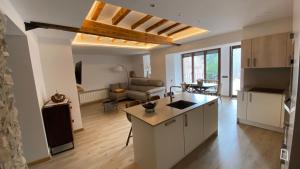 an open kitchen and living room with a couch at Pis turístic de 170 m2 a la plaça Porxada de Bagà in Bagá