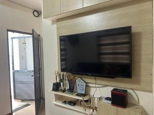 a flat screen tv on a wall in a living room at Nasugbu or Tuy - Entire House at RCD Royale Homes in Tuy