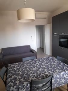 a living room with a table and a couch at Apartment Emanuela in Porto Cesareo