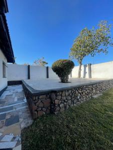 a stone retaining wall with a planter on top at The Extension in Umtali +6 photos