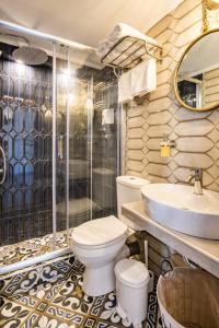 a bathroom with a toilet and a sink and a shower at Gorgona Traditional 3 in Karpathos Town +34 photos