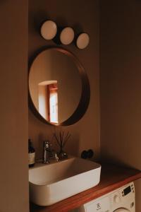 a bathroom with a sink and a mirror at K&L Old Town Kuldīga in Kuldīga +35 photos
