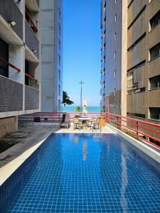 a swimming pool in the middle of two buildings at Mercure Recife Navegantes - Privado in Recife