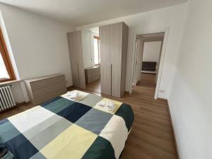 a bedroom with a bed with a striped blanket at Casa da Paolino in Porto Ceresio