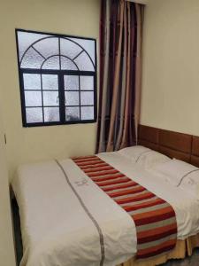 Letto o letti in una camera di Harbin Qiju Hotel Taiping International Airport