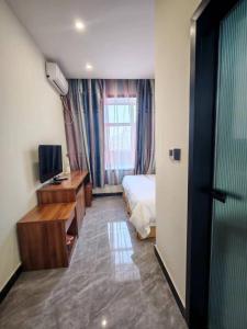 TV o dispositivi per l'intrattenimento presso Harbin Qiju Hotel Taiping International Airport