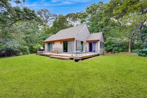 a small house in a field with a large yard at Chilmark Guest House in Chilmark