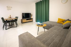 a living room with a couch and a table at Apartmani Ante & Ivano Biograd with POOL in Biograd na Moru