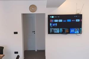 a flat screen tv hanging on a wall in a room at Mediterranean 5 rooms house with pool in Ramljane